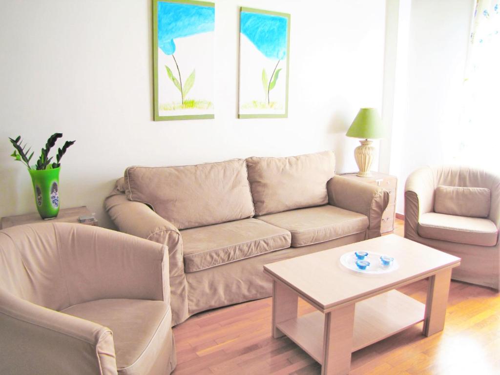 a living room with a couch and a table at Athens Quality Apartments in Athens