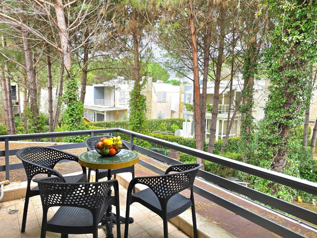 a table with a bowl of fruit on a balcony at Lura 3 Holiday Homes 178 in Lalzit Bay