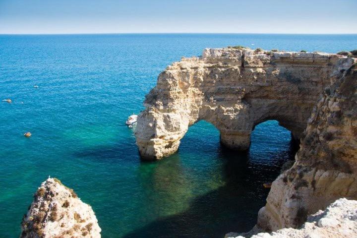 a rock formation in the water next to the ocean at Casa Paraiso - stylish gateway in Carvoeiro