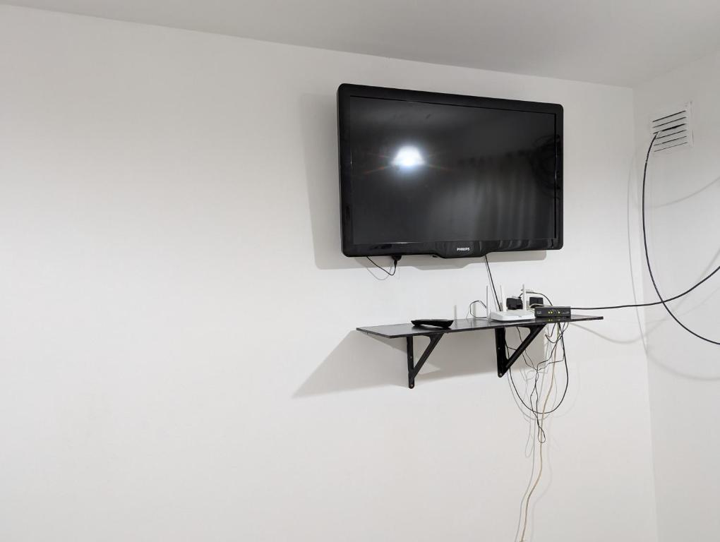 een flatscreen-tv aan een witte muur bij dale dpto in Chilecito