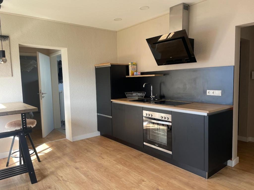 a kitchen with a stove and a tv on the wall at 70 qm Wohnung in Neuwied