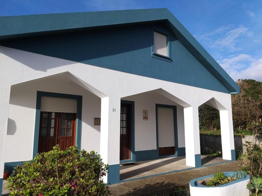 a house with a blue roof at Azul 31 in Lajes das Flores