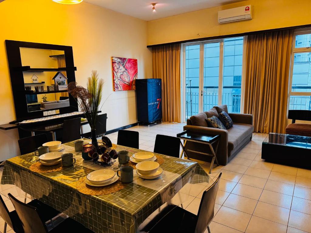 a living room with a table and a couch at 126 Bukit Ceylon 5 minutes KLCC Jalan Alor Pavilion Bukit Bintang 2R2B 8Pax in Kuala Lumpur