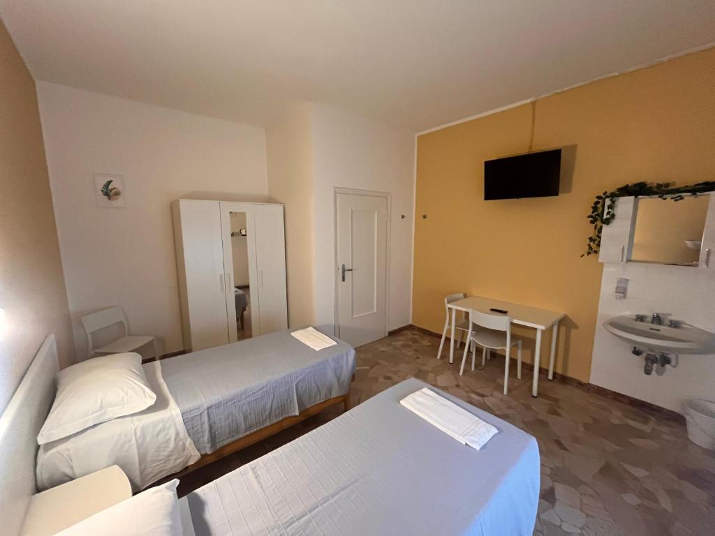 Ліжко або ліжка в номері Hotel Parini