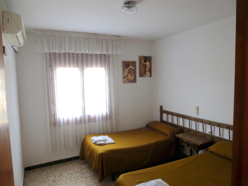 Postel nebo postele na pokoji v ubytování Hostal Roca
