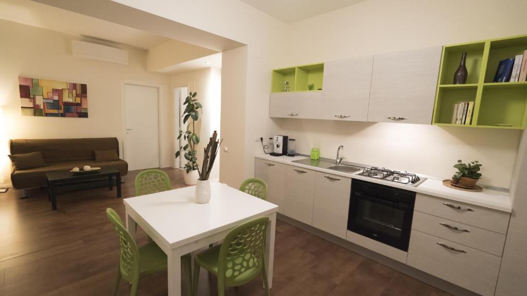 a kitchen and living room with a table and chairs at Le Lune di Diana in Matera