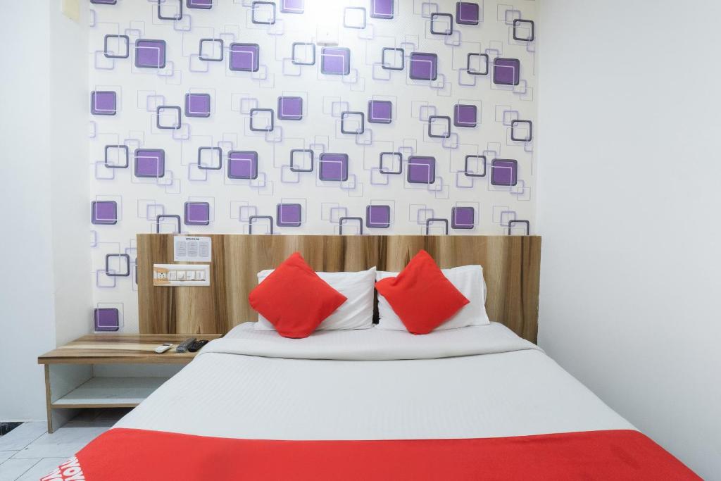 Postel nebo postele na pokoji v ubytování Hotel O Swell