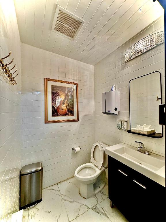 a bathroom with a toilet and a sink at Royal Oak Inn in Toronto