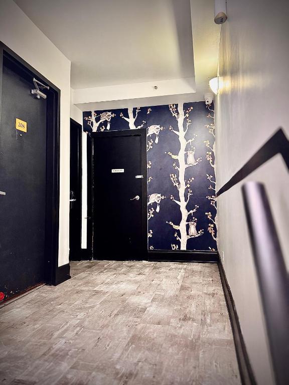 a hallway with a black and white wall at Royal Oak Inn in Toronto