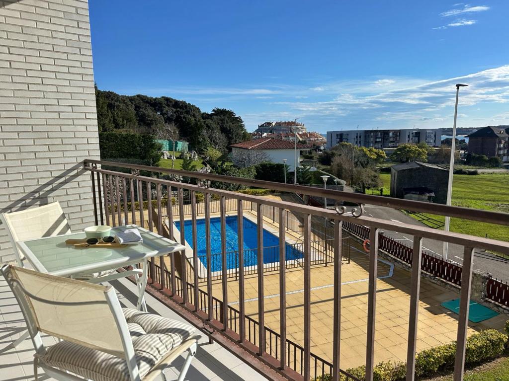 a balcony with a table and chairs and a pool at Cinco Soles - 5927 in Isla