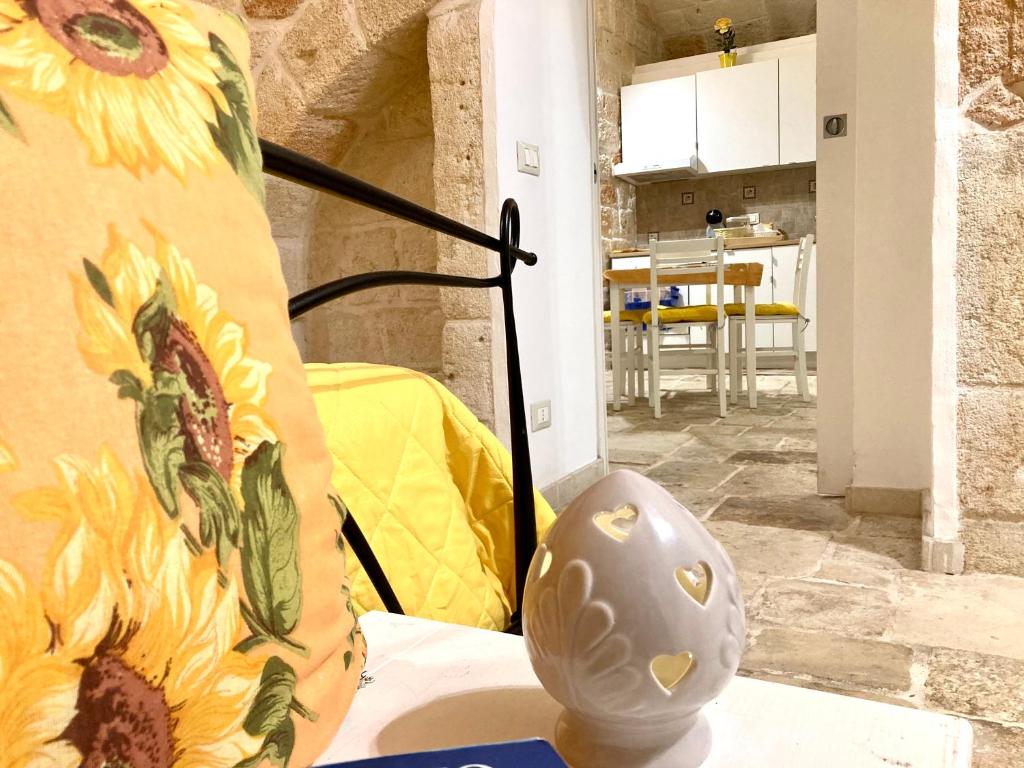 a vase sitting on a table in a room at Antica Pietra in Polignano a Mare