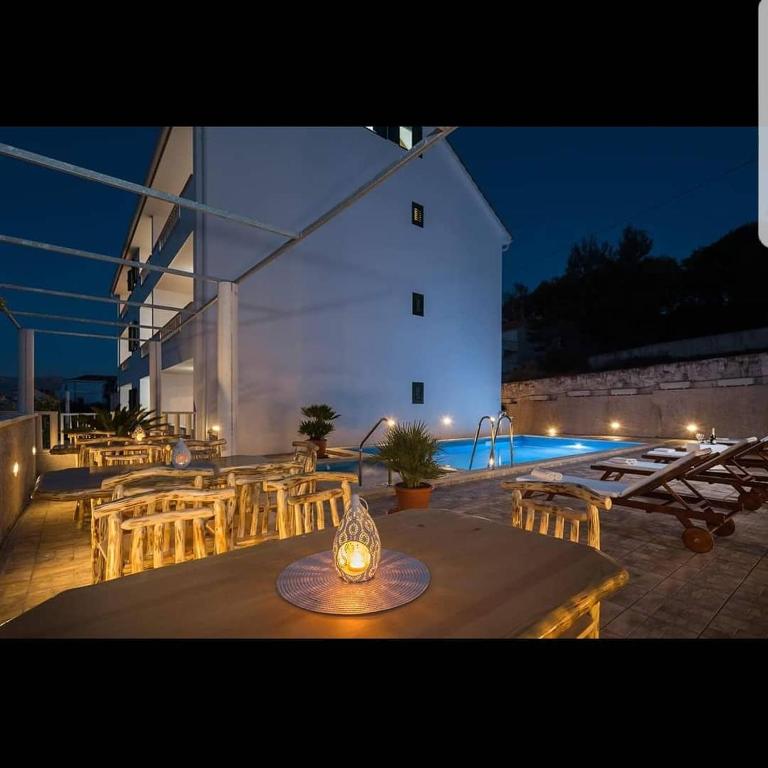 a patio with a table and chairs and a pool at La Perla apartments 3 in Sutivan