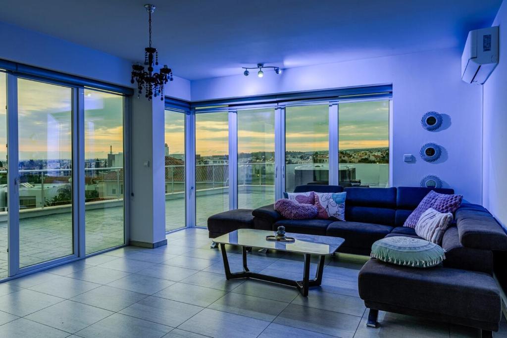 a living room with a couch and a table at Sky villa penthouse with private outdoor hottub in Limassol