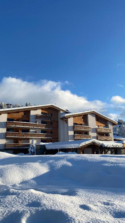 a building with snow in front of it at Hôtel Rent in Megève
