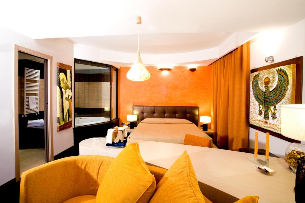 Postel nebo postele na pokoji v ubytování Grand Hotel Olimpo