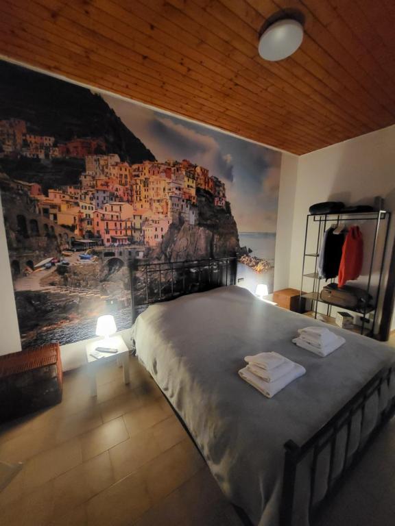 a bedroom with a large bed with a painting on the wall at Da Pietro e Sandra in La Spezia