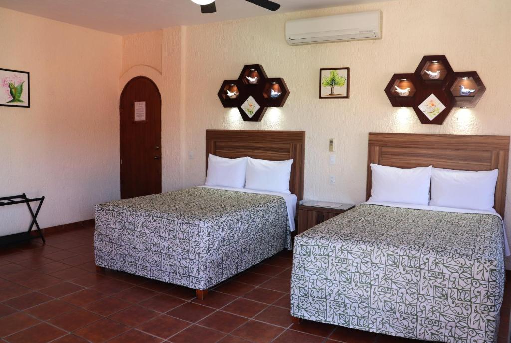 Postel nebo postele na pokoji v ubytování HOTEL CASA DE LAS PALOMAS