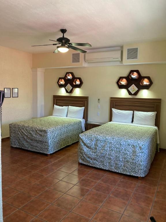 Postel nebo postele na pokoji v ubytování HOTEL CASA DE LAS PALOMAS