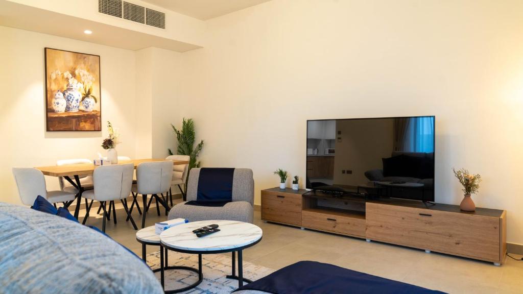 a living room with a large flat screen tv at Luxury Villa In Yas in Abu Dhabi