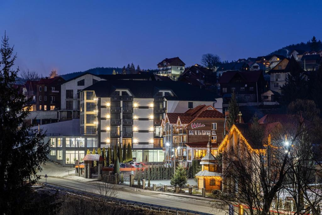 a hotel in a city at night with buildings at Milana SPA & Hotel - SPA included in Bukovel