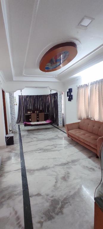 a living room with a couch and a table at Mahuri home stay in Visakhapatnam