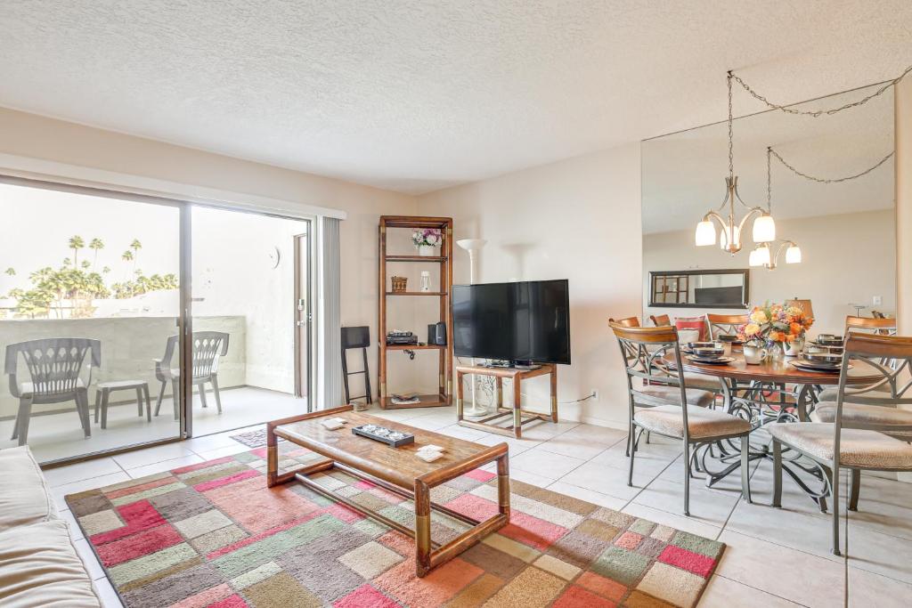 a living room with a couch and a dining room at 3 Mi to Dtwn Palm Springs Condo with Pool Access! in Palm Springs
