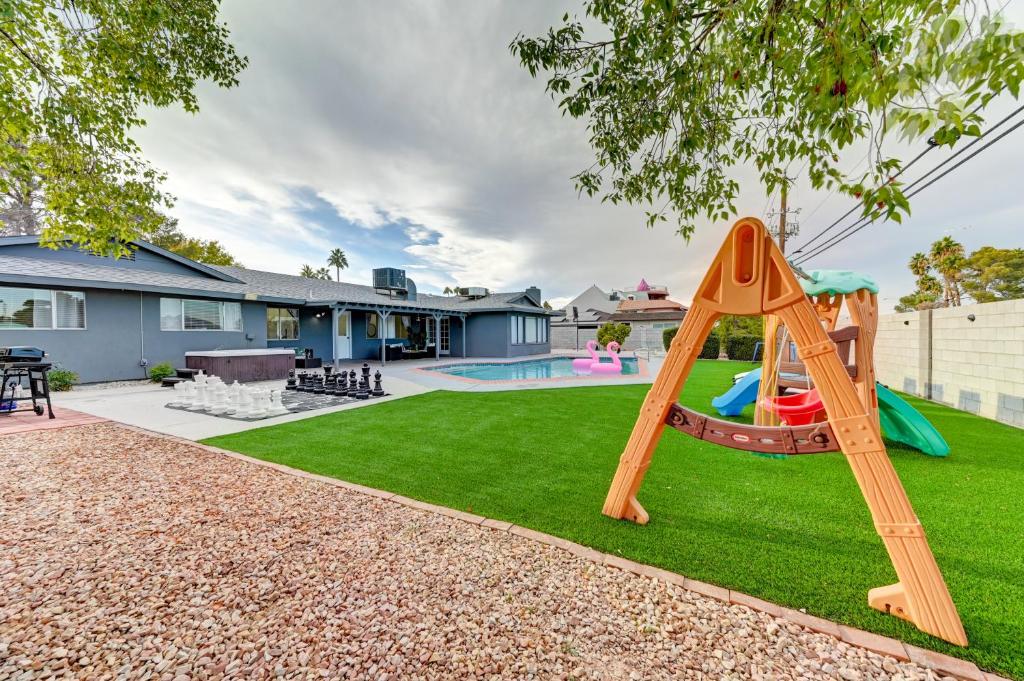 a playground with a slide in a yard at Vila Paradise-Luxury 5BD Retreat Perfect for Groups & Families in Las Vegas