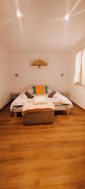 une chambre avec deux lits et un parquet dans l'établissement Colibri, à Val-des-Prés