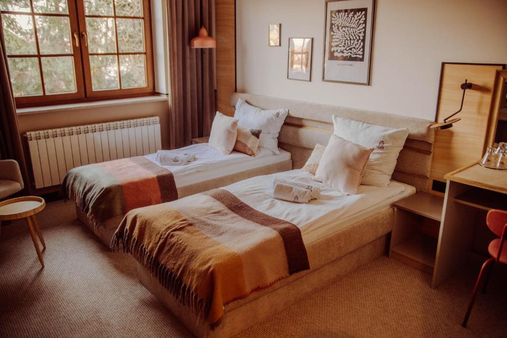 a hotel room with two beds in a room at Dworek in Kolbuszowa