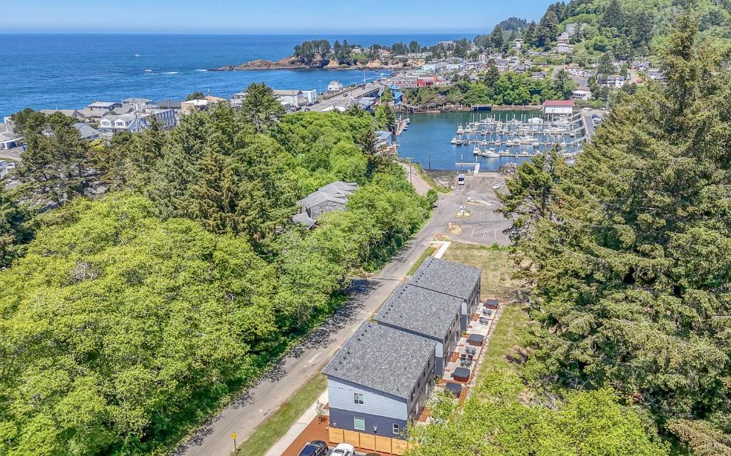 an aerial view of a town and a harbor with boats at Harbor Lights 2 Family Fun Retreat Coastal Comfort in Depoe Bay