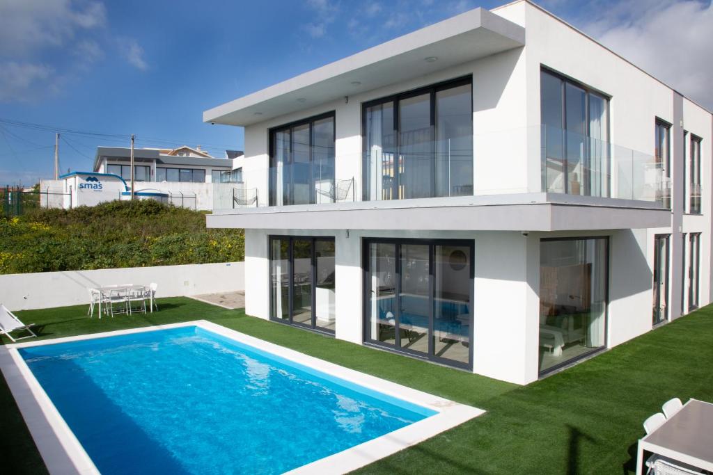 una casa con una piscina di fronte di Palhais Paradiso - perfect for families & friends a Santo Isidoro