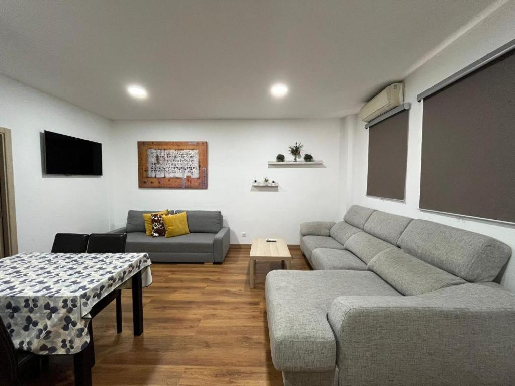 a living room with a couch and a table at Hello Home Canillas in Madrid