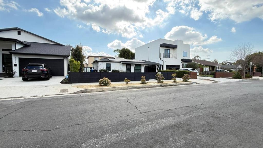 a street with houses and a car parked on the road at Modern Studio Stylish &Cozy Back Unit in Los Angeles