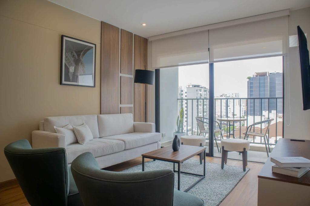 a living room with a couch and a table at Aguirre By Wynwood House in Lima