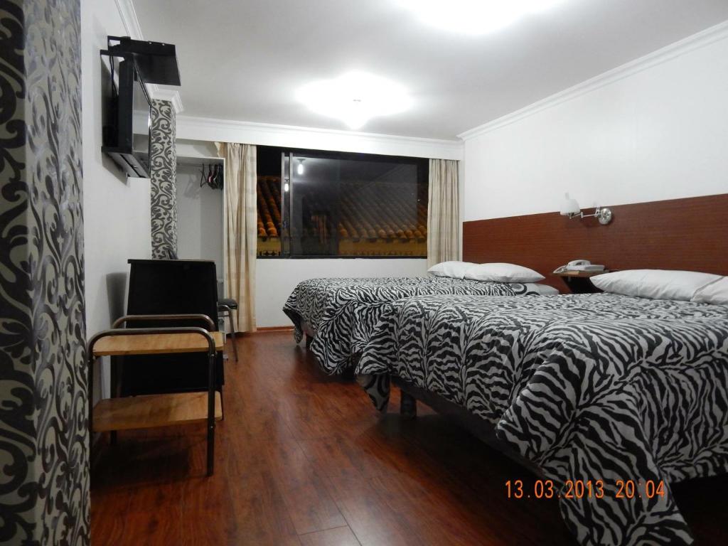 Postel nebo postele na pokoji v ubytování Gran Hotel Napoleón