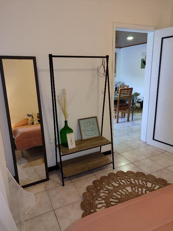 a room with two mirrors and a table with a vase at Marques House in Machico
