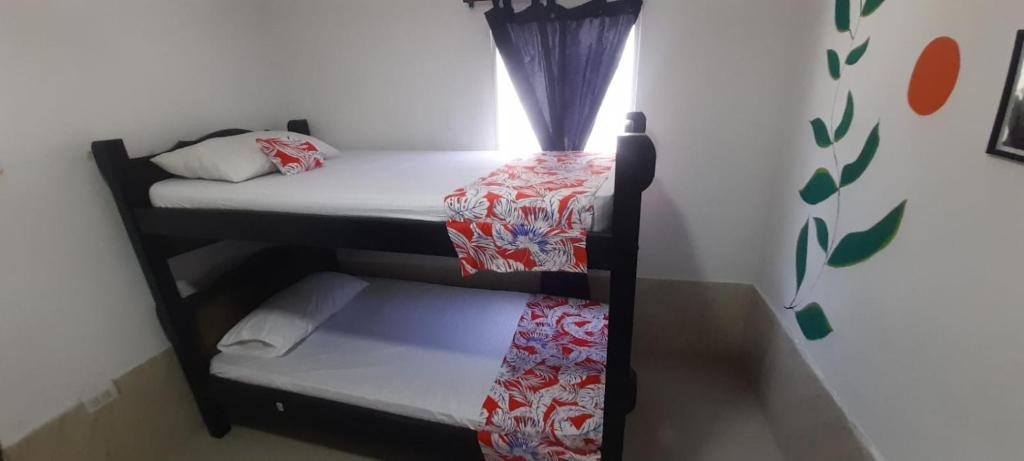 Postel nebo postele na pokoji v ubytování Caribe Sunshine Gold Hostel 1 habitacion