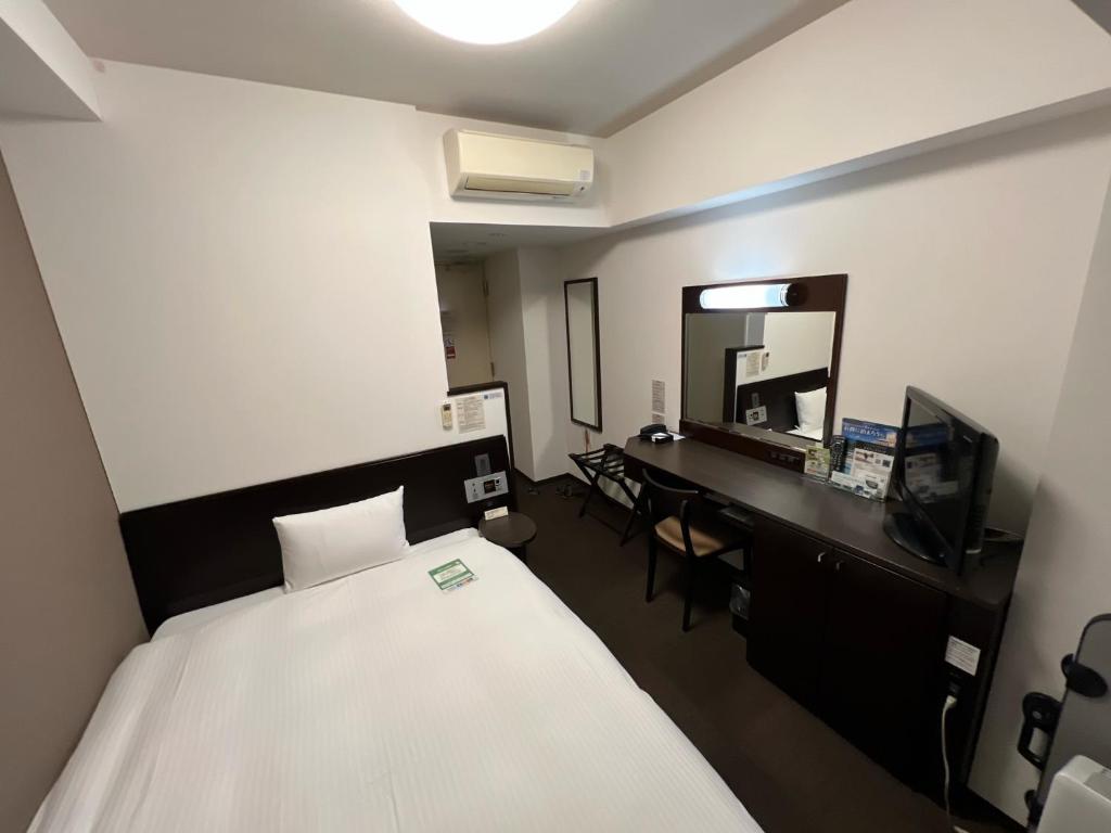Postel nebo postele na pokoji v ubytování Hotel Route-Inn Uozu
