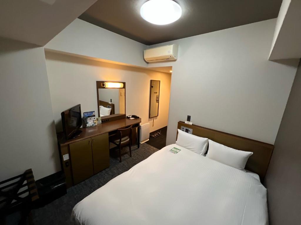 Postel nebo postele na pokoji v ubytování Hotel Route-Inn Uozu