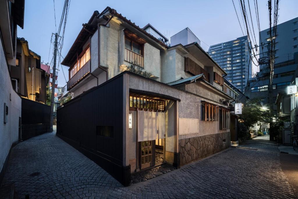a building on a street in a city at Trunk House in Tokyo