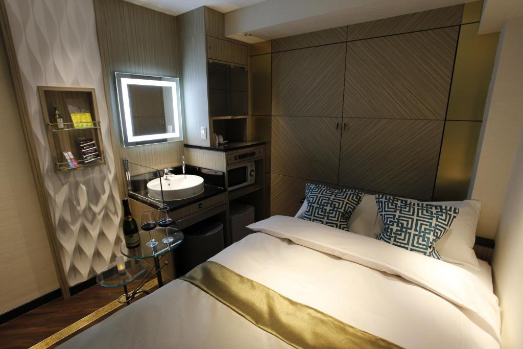 Postel nebo postele na pokoji v ubytování Hotel Moana Shinjuku (Adult Only)