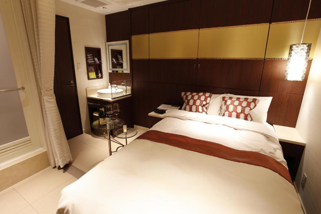 Postel nebo postele na pokoji v ubytování Hotel Moana Shinjuku (Adult Only)