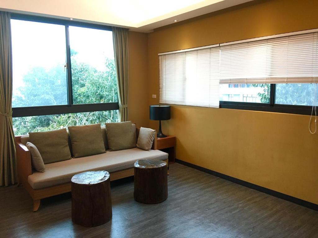 a living room with a couch and some windows at Great Nature Villa in Jiji