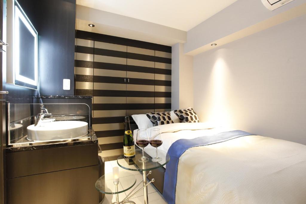 Postel nebo postele na pokoji v ubytování Hotel Moana Shinjuku (Adult Only)