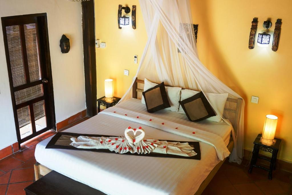 Postel nebo postele na pokoji v ubytování Mealea Resort