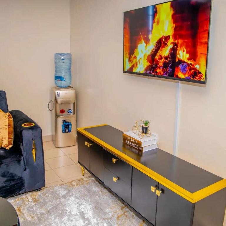 a desk in a room with a painting on the wall at Bahati homes 2 in Kisii