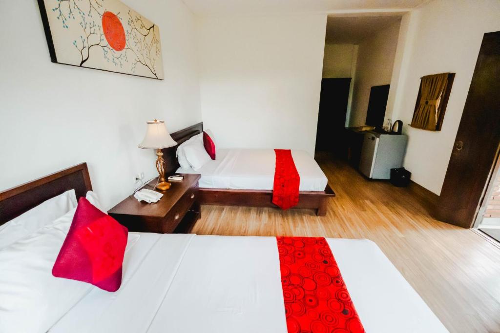 Postel nebo postele na pokoji v ubytování Sri Aksata Ubud Resort