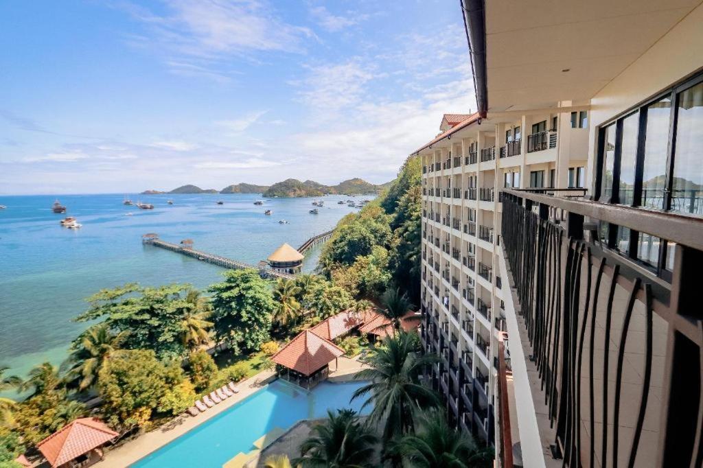 a view of the water from a balcony of a building at Laprima Hotel in Labuan Bajo