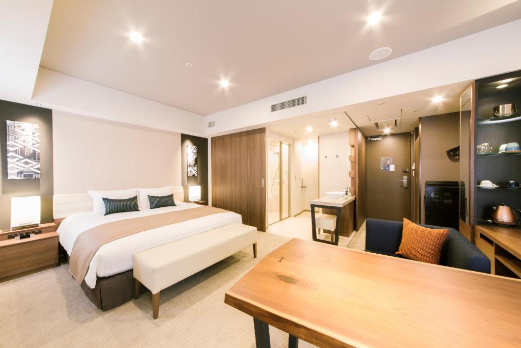 a hotel room with a bed and a desk at Tokyu Stay Ginza in Tokyo