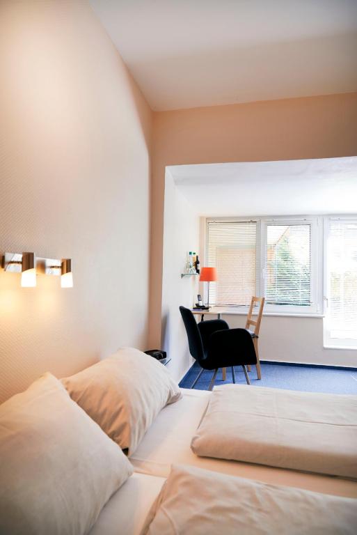 Postel nebo postele na pokoji v ubytování Hotel Am Mühlenteich